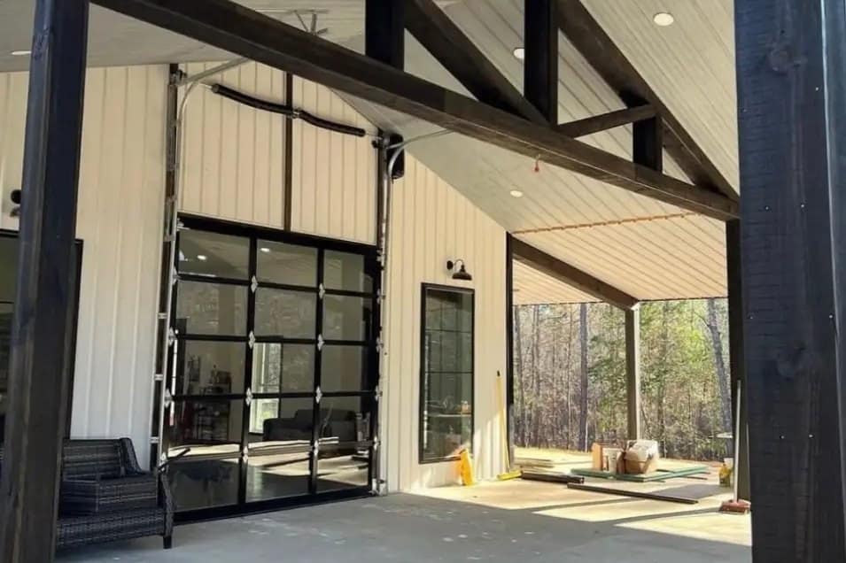 barndominium covered patio timber truss glass overhead door detail