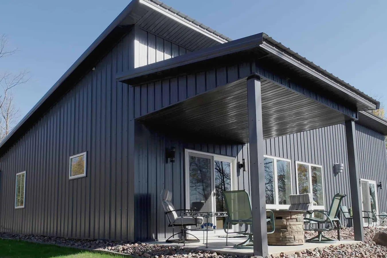 barndominium dark metal vertical panel gable covered patio