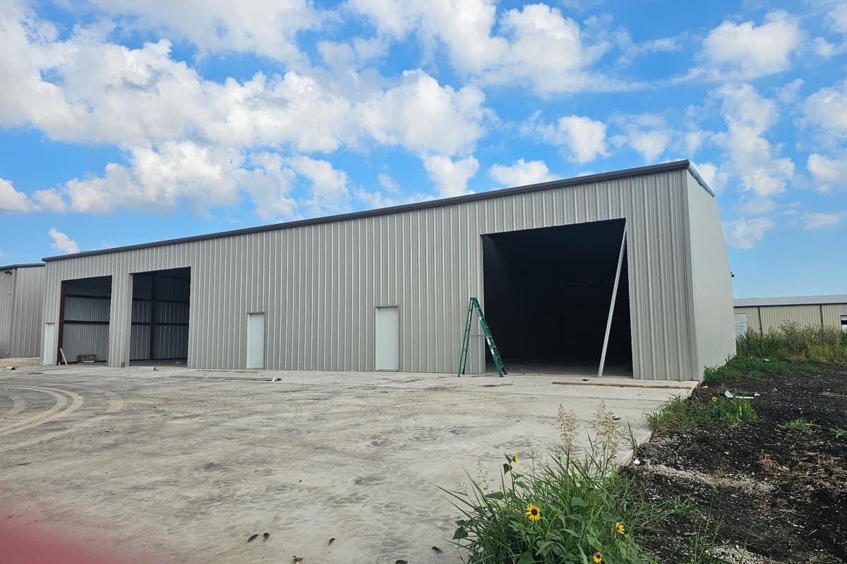 industrial shop tall open bay doors concrete apron