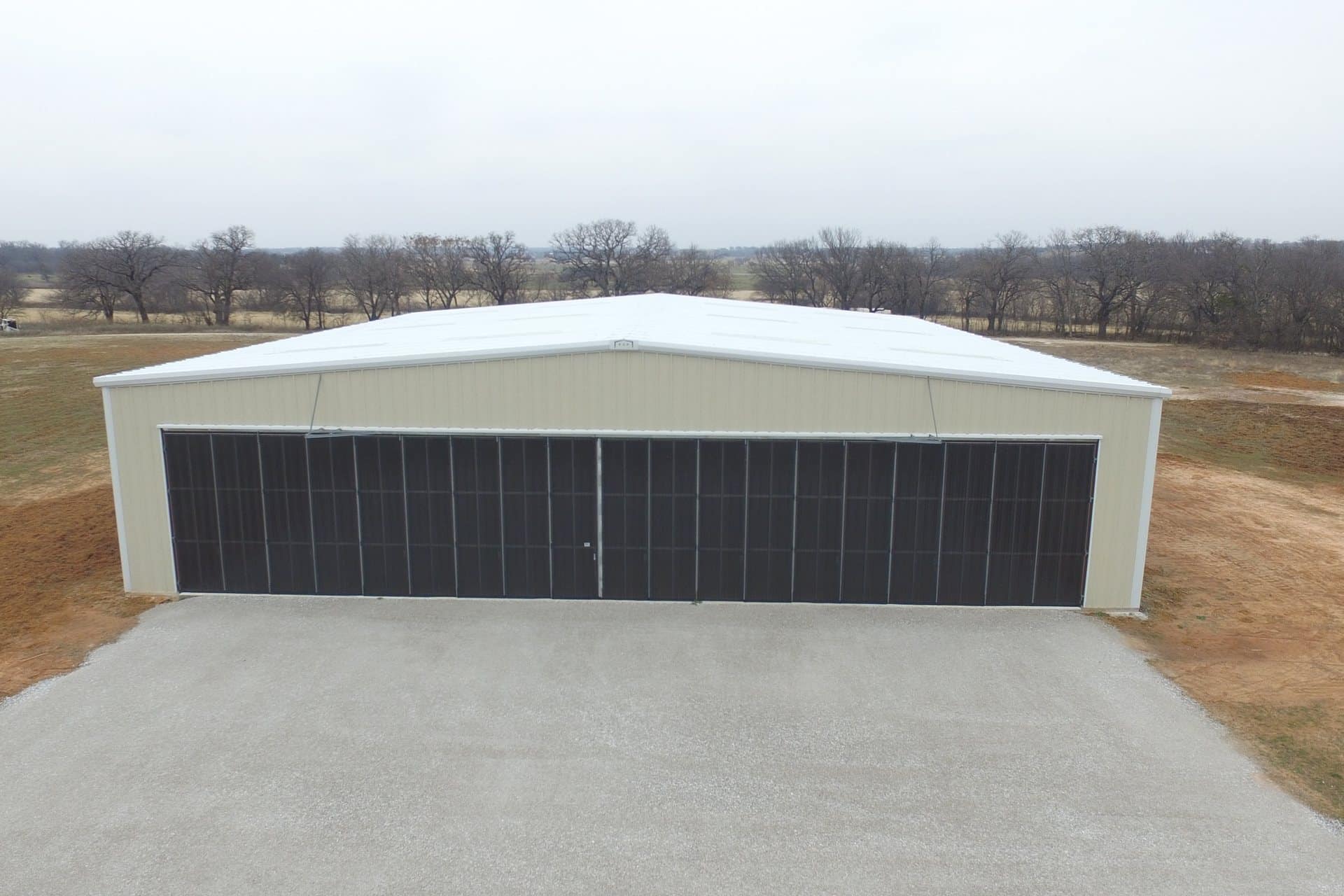 aircraft hangar full width door open span tan metal rural airstrip