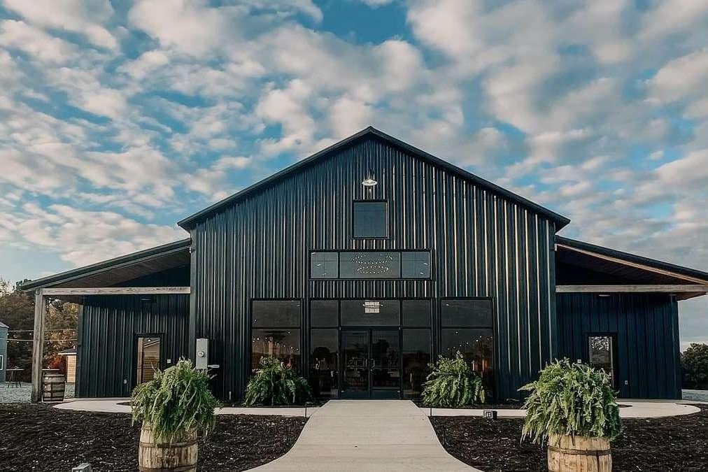 event venue dark metal gable entry glass storefront