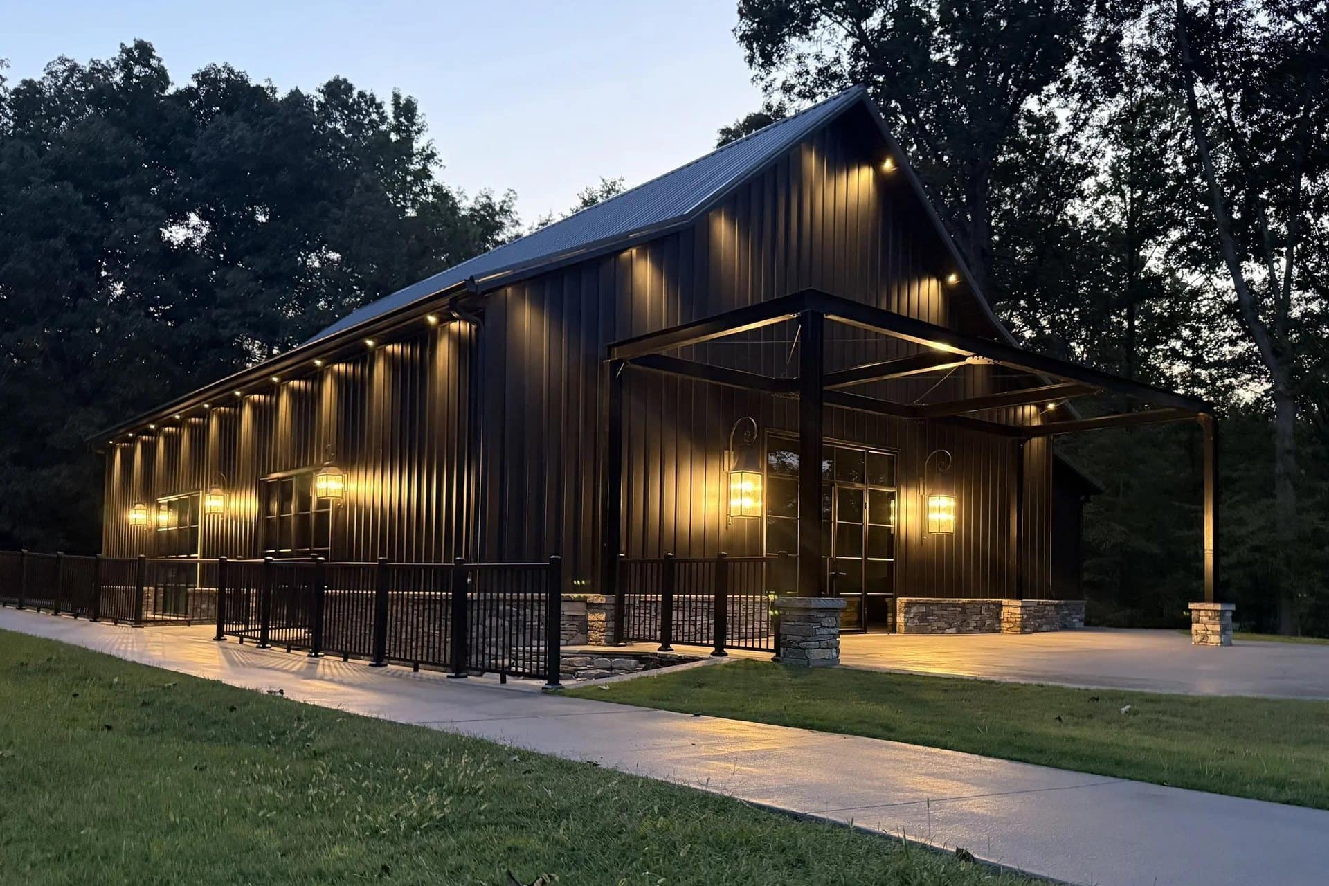 event venue dark metal lit covered entry at dusk