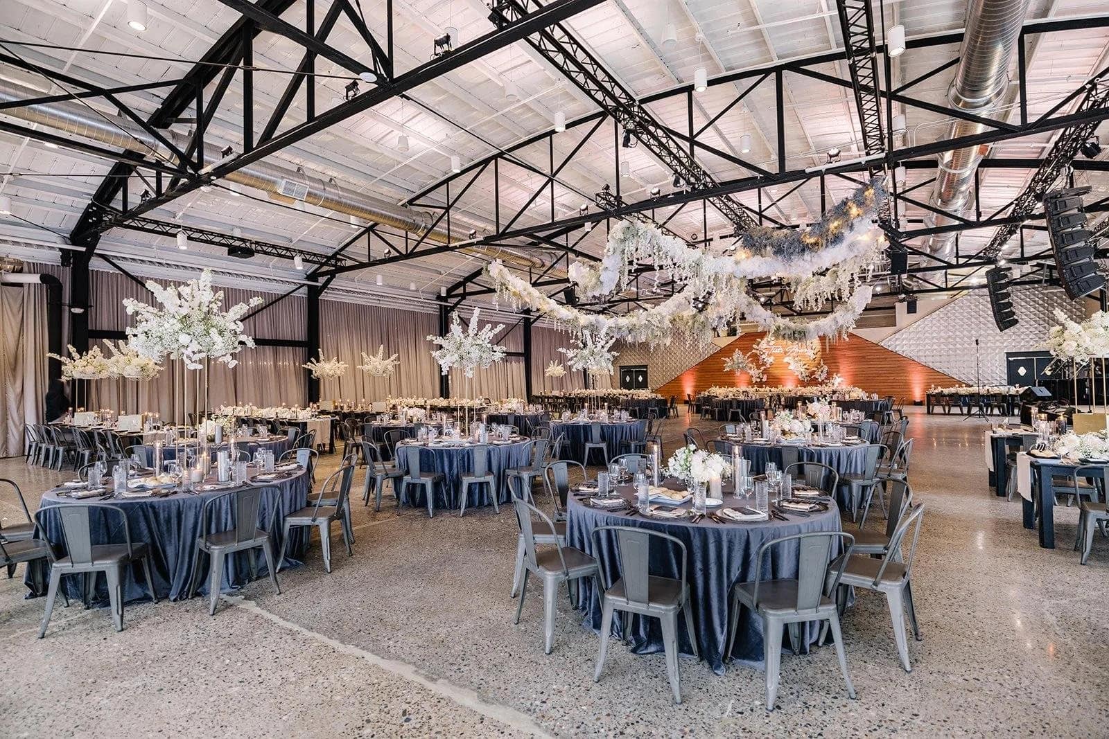 event venue interior black steel trusses set for reception