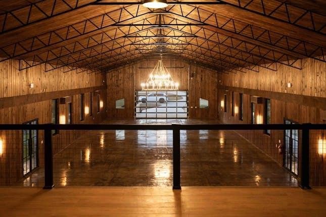 event venue interior timber walls open web trusses mezzanine rail