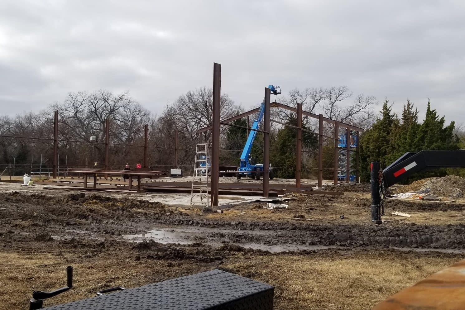 steel columns erected on slab overcast day with boom lift and crew