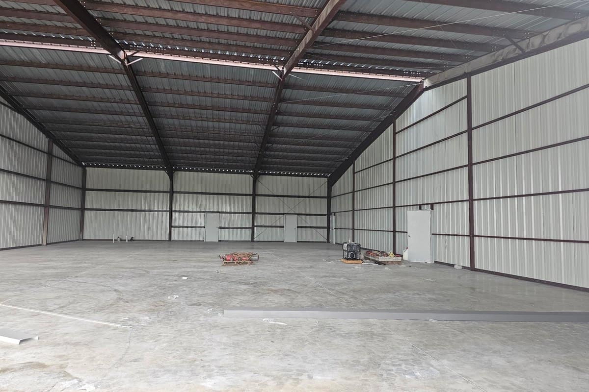 warehouse interior red iron clear span frame finished slab