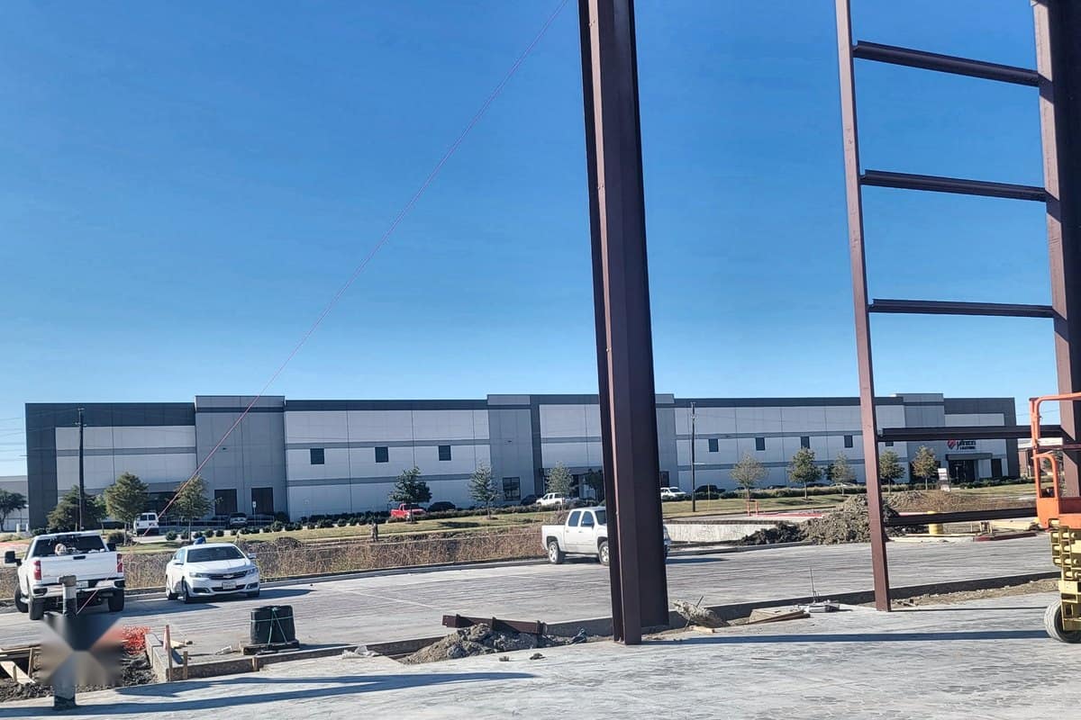 red iron frame erected over finished slab commercial site