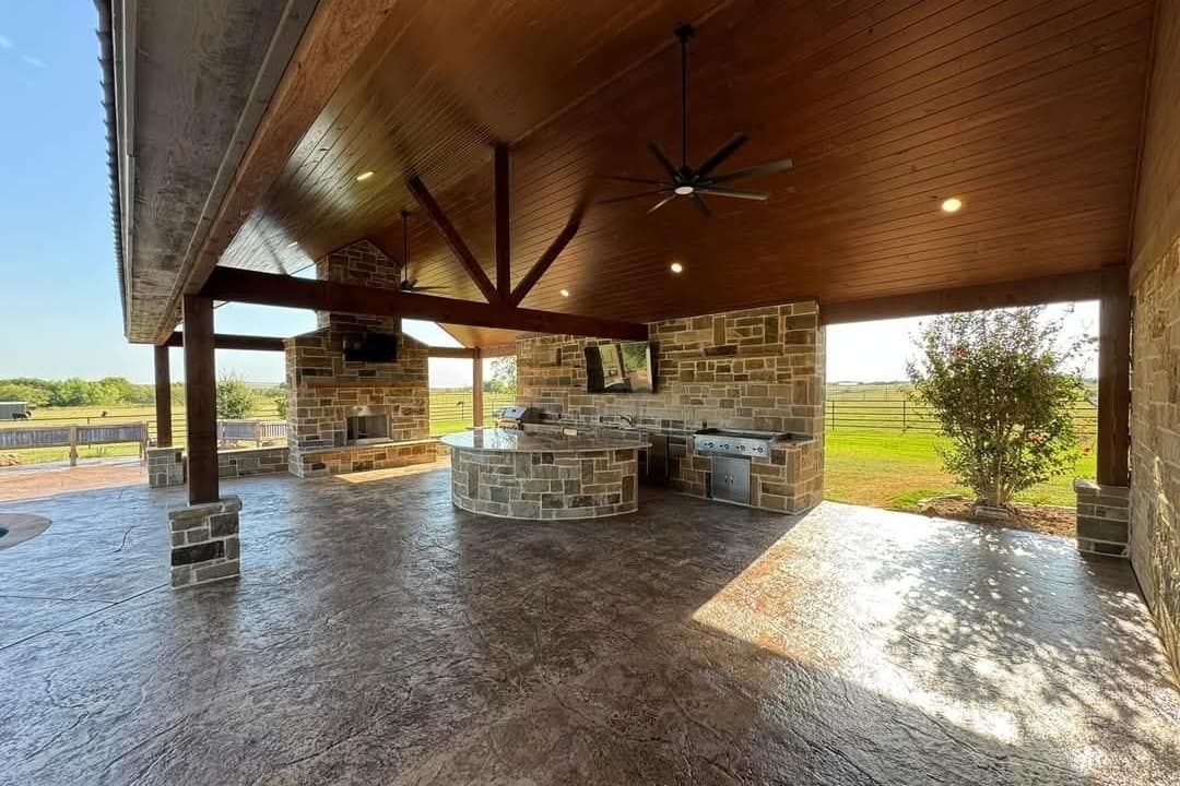 covered pavilion stone outdoor kitchen timber truss stamped concrete
