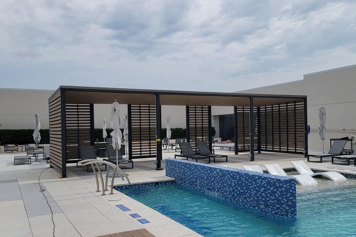 resort pool cabana black steel louvered screens poolside