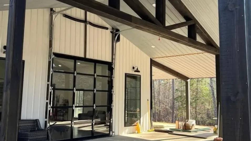 barndominium covered patio timber truss glass overhead door detail