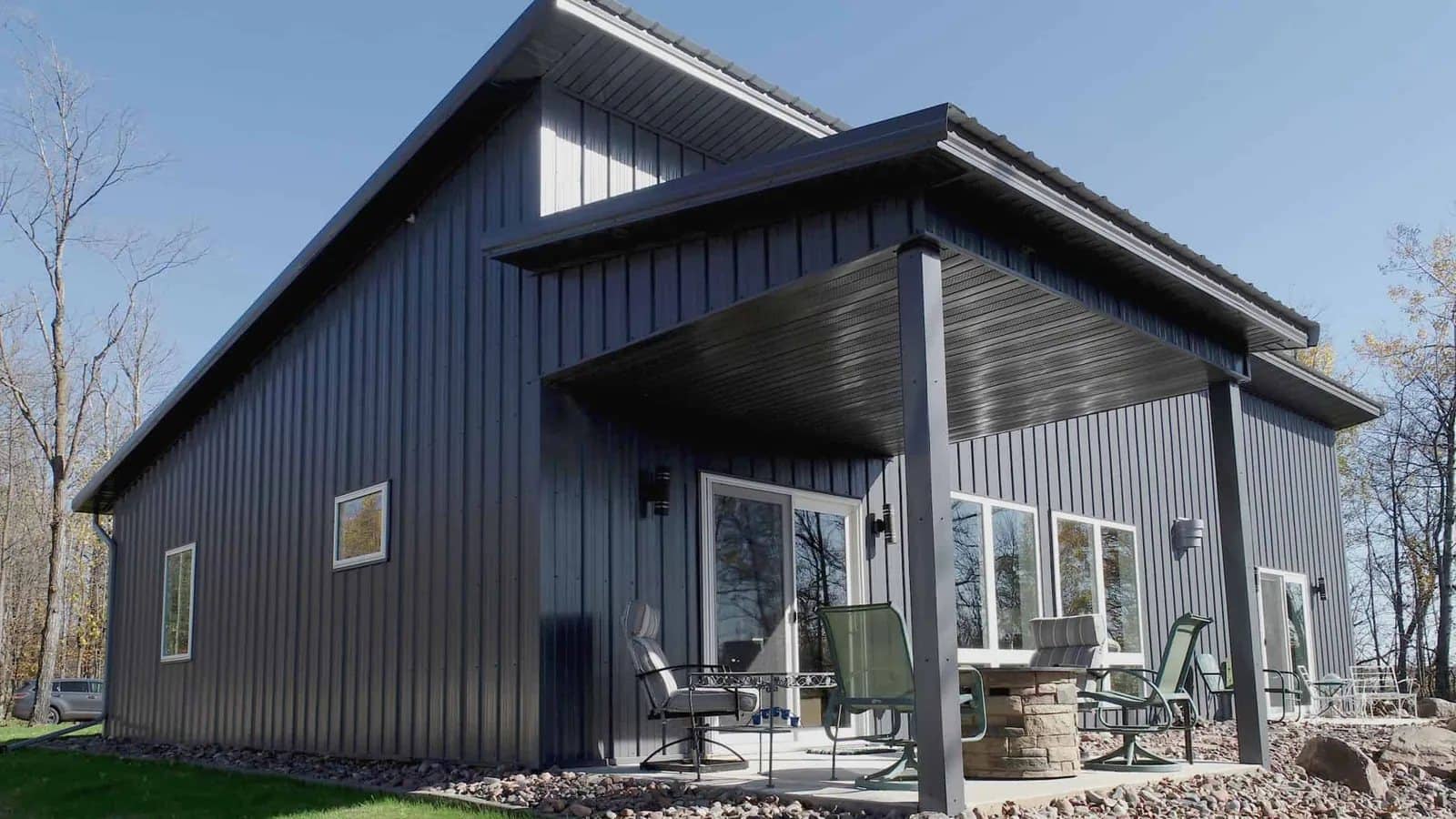 barndominium dark metal vertical panel gable covered patio