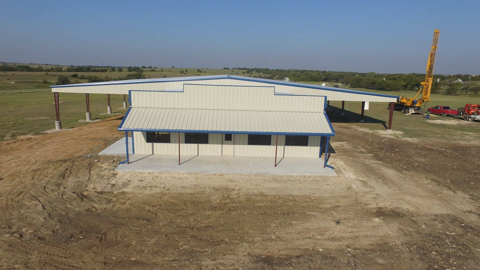 agricultural equipment building with wide covered lean to bays