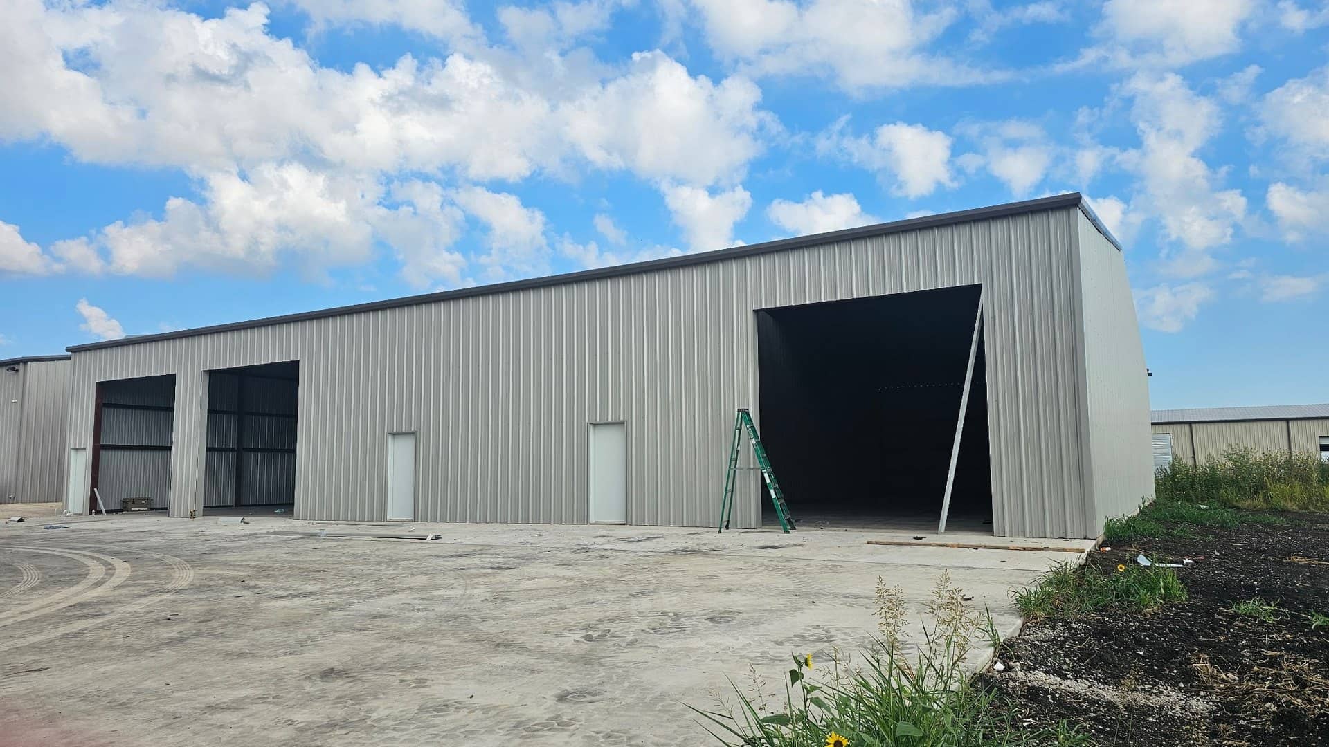 industrial shop tall open bay doors concrete apron