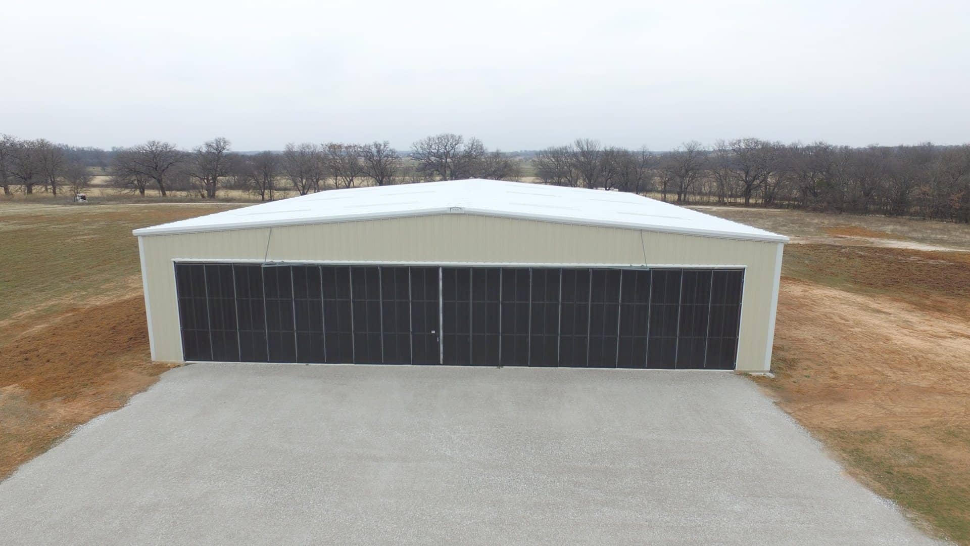 aircraft hangar full width door open span tan metal rural airstrip