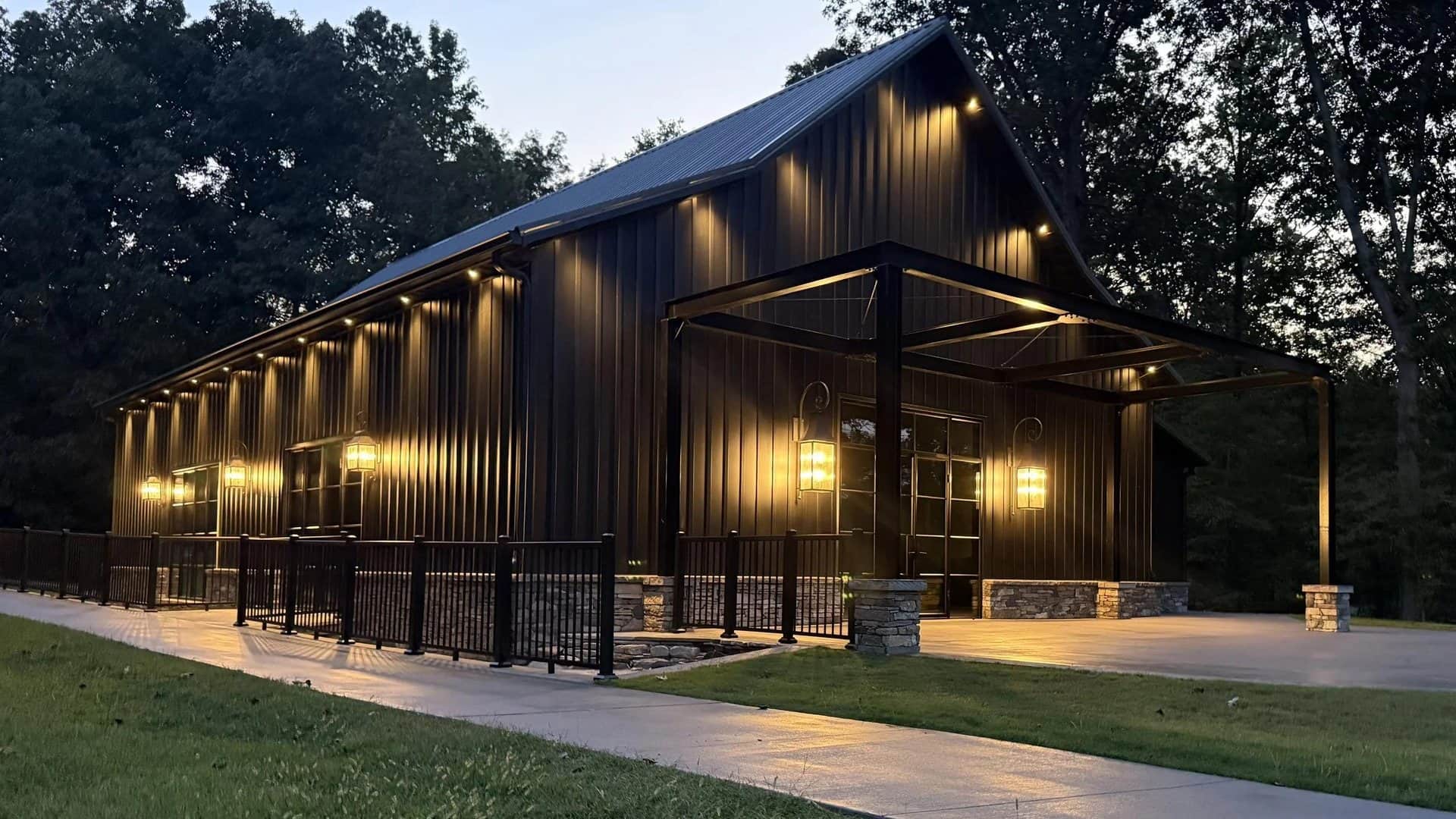 event venue dark metal lit covered entry at dusk