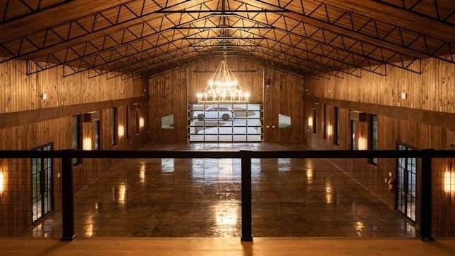 event venue interior timber walls open web trusses mezzanine rail