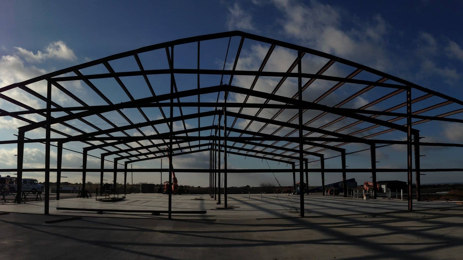 red iron frame silhouette clear span erected over finished slab