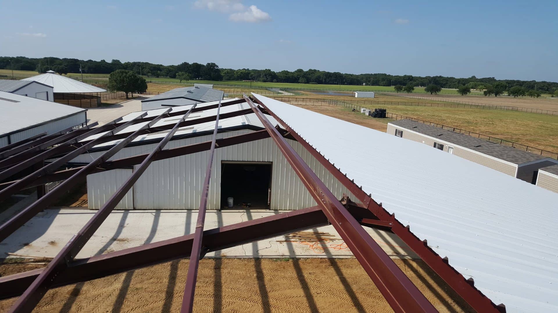 roof purlins and standing seam panels going on viewed from the ridge