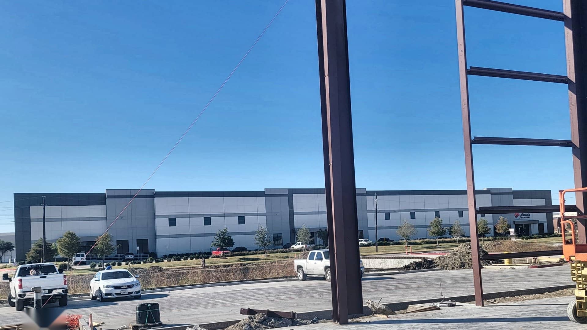 red iron frame erected over finished slab commercial site