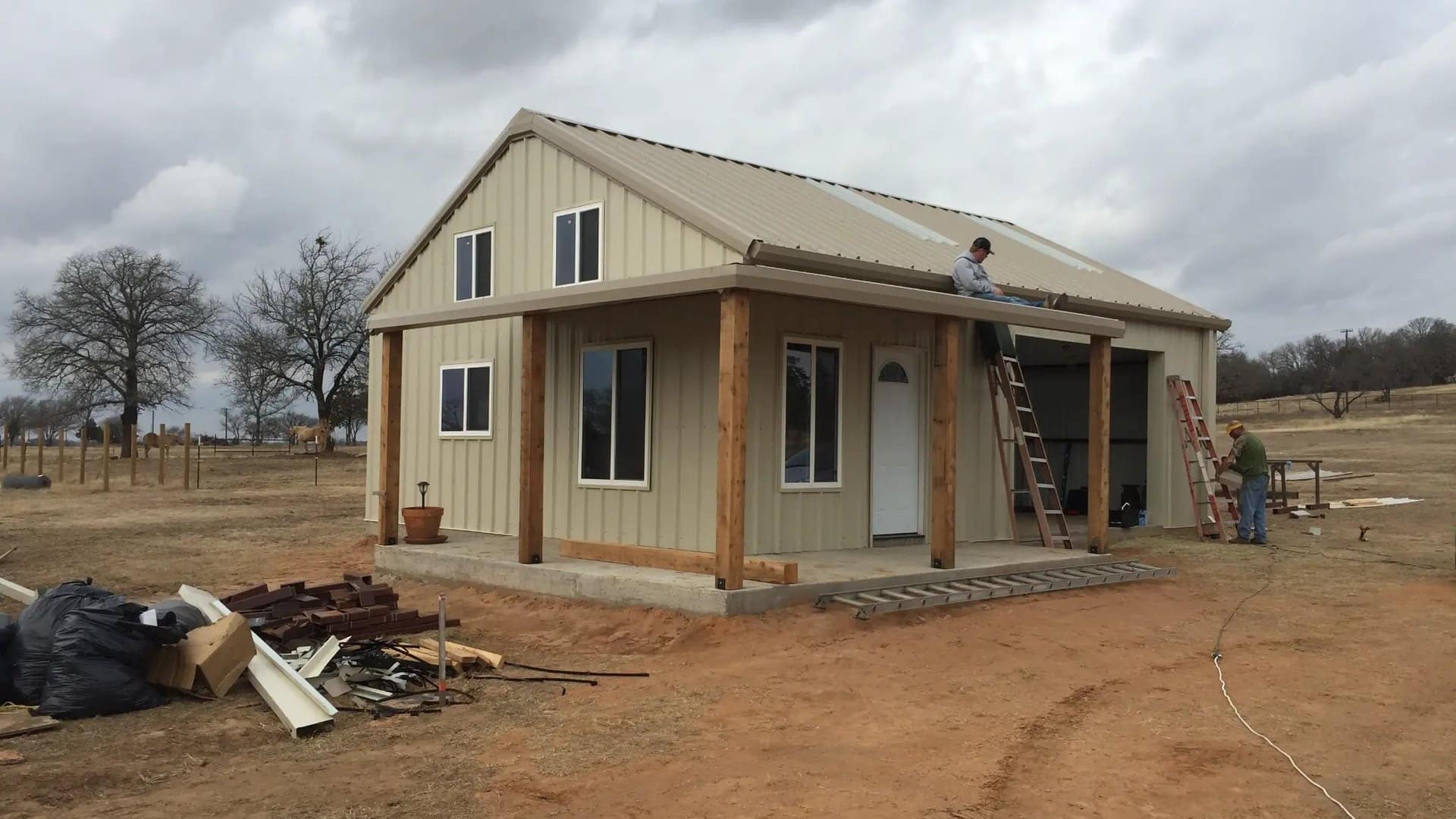 barndominium shell roof and porch framing crew working