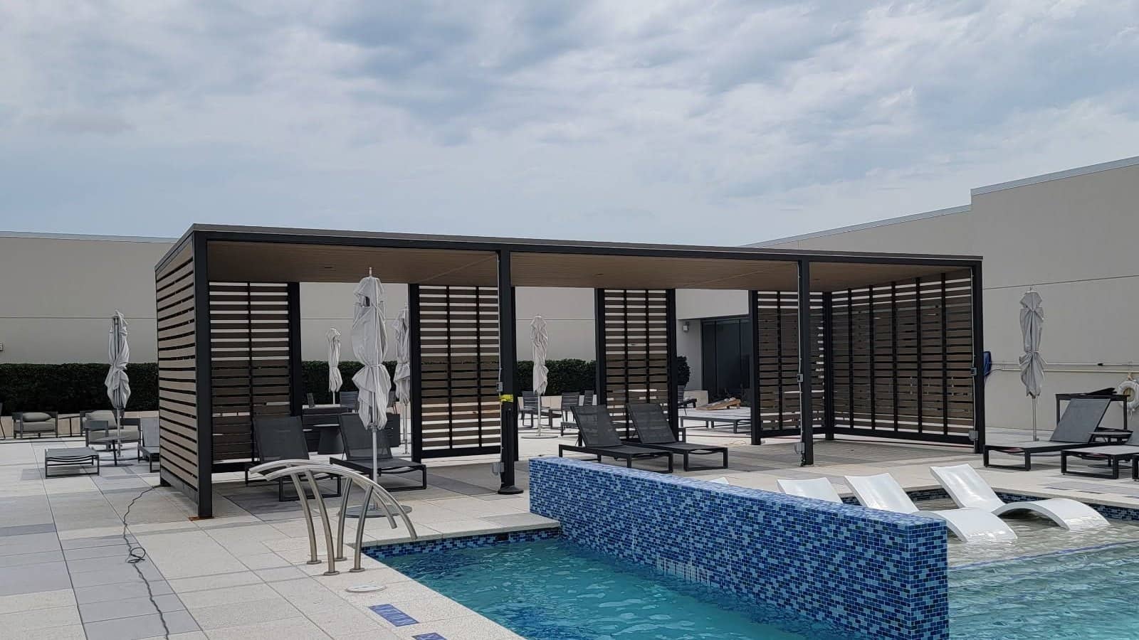 resort pool cabana black steel louvered screens poolside
